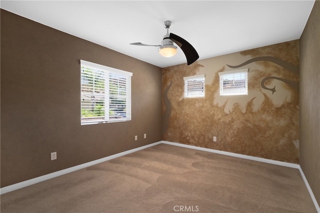 carpeted empty room featuring ceiling fan