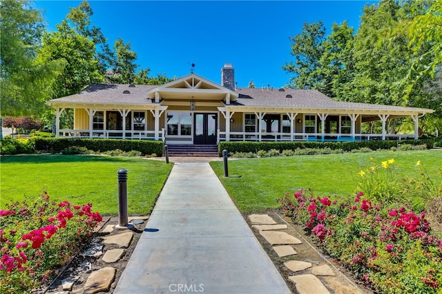 view of front of house with a porch and a front yard