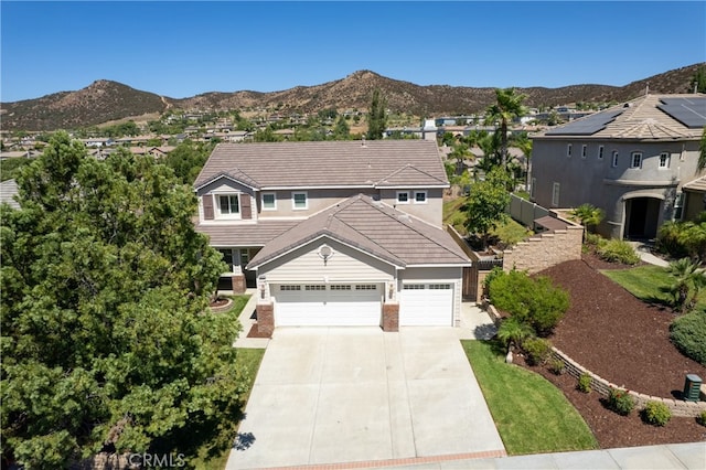 view of front of home featuring a mountain view and a garage