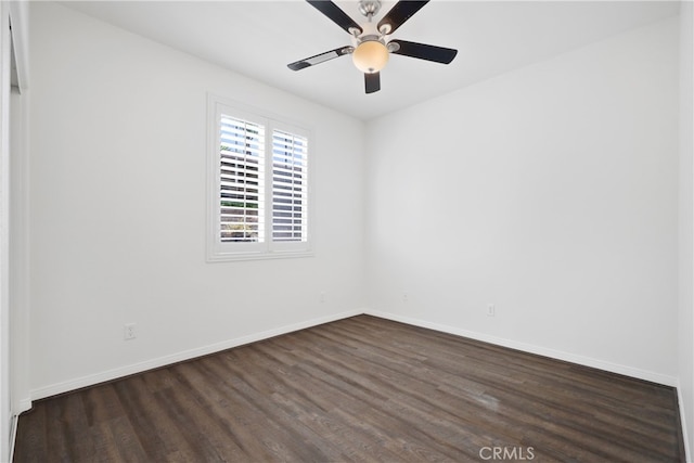 empty room with ceiling fan and dark hardwood / wood-style flooring