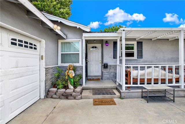 doorway to property with a garage