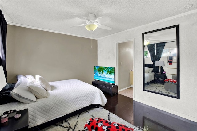 bedroom featuring ceiling fan, crown molding, hardwood / wood-style floors, ensuite bathroom, and a textured ceiling