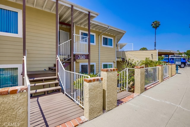 doorway to property featuring fence