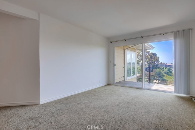 unfurnished room with baseboards and carpet floors