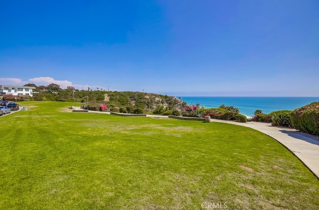 surrounding community featuring a water view and a yard