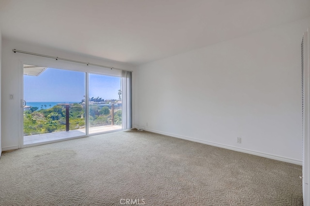 spare room with carpet and baseboards