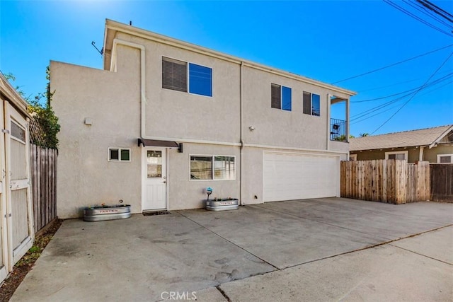 rear view of house featuring a garage