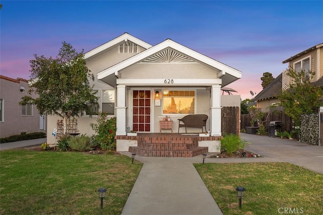 view of front of house featuring a yard and covered porch