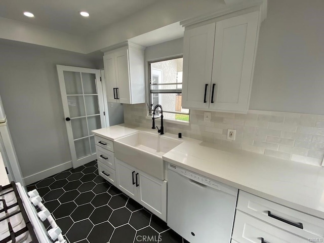 kitchen with white cabinets, decorative backsplash, sink, and white dishwasher