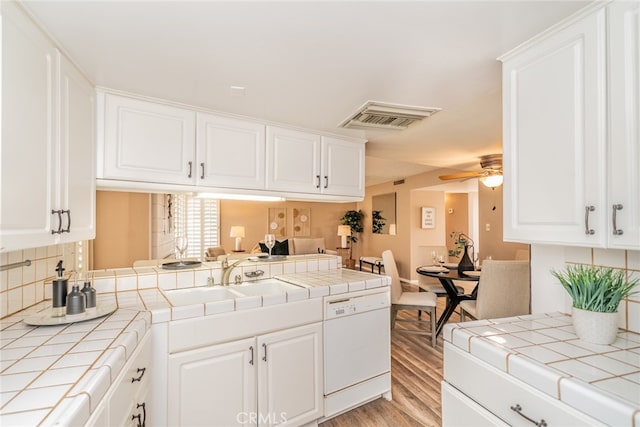 kitchen featuring white dishwasher, tile countertops, and ceiling fan