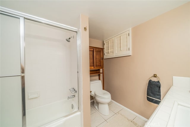 bathroom with tile patterned flooring, combined bath / shower with glass door, and toilet