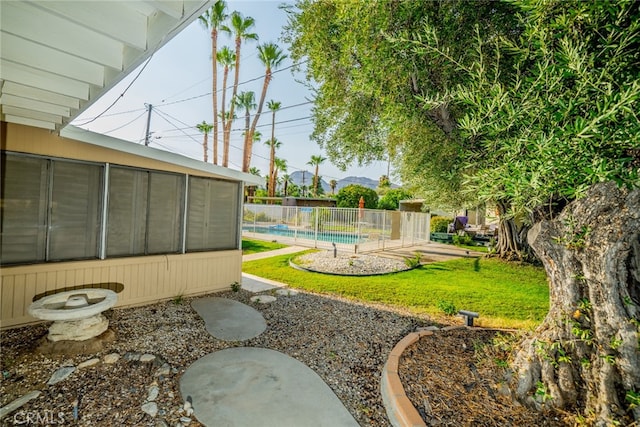 view of yard featuring a fenced in pool