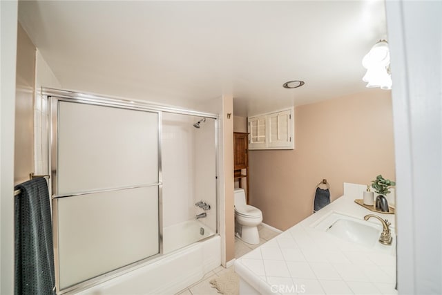 full bathroom with vanity, tile patterned flooring, bath / shower combo with glass door, and toilet