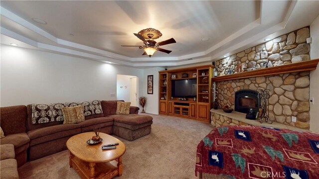 919 Venus Way, Crestline, CA 92325 - living area with ceiling fan, a fireplace, a raised ceiling, and light colored carpet