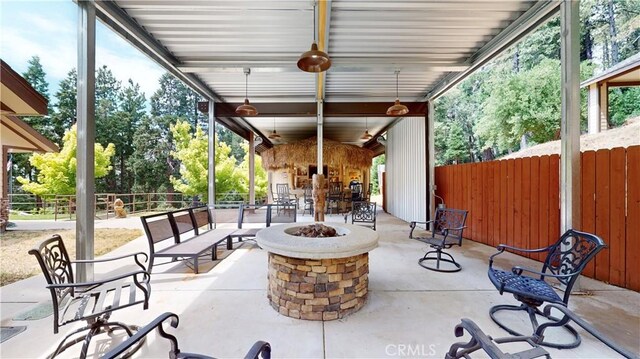 919 Venus Way, Crestline, CA 92325 - view of patio / terrace with an outdoor fire pit, a fireplace, fence, and a ceiling fan
