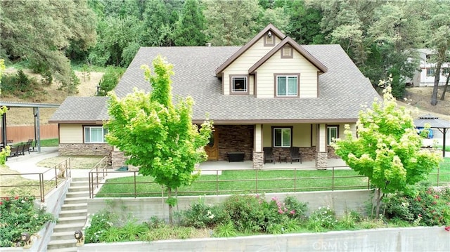 919 Venus Way, Crestline, CA 92325 - view of front facade with stone siding, stairway, a fenced front yard, and roof with shingles