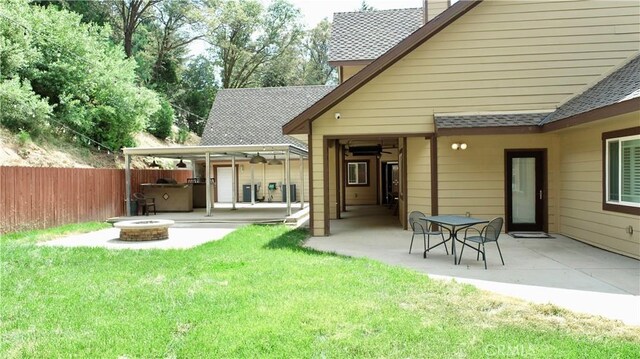 919 Venus Way, Crestline, CA 92325 - rear view of house featuring a patio area, a shingled roof, fence, and a fire pit
