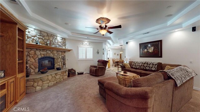 919 Venus Way, Crestline, CA 92325 - living room with a tray ceiling, visible vents, light carpet, ceiling fan, and a stone fireplace