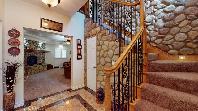 919 Venus Way, Crestline, CA 92325 - stairway featuring ceiling fan, baseboards, and a stone fireplace