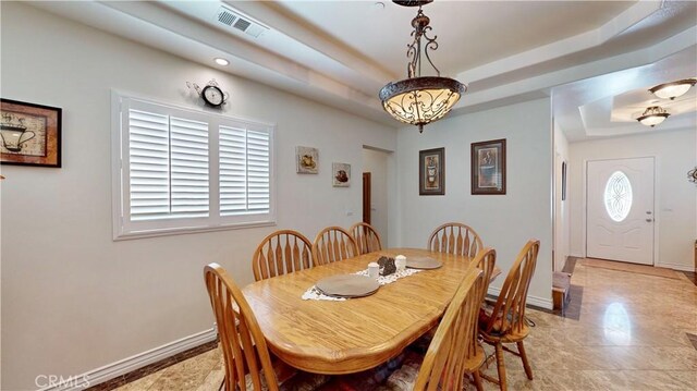 919 Venus Way, Crestline, CA 92325 - dining space with visible vents, a tray ceiling, and baseboards