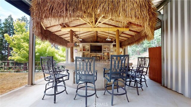 919 Venus Way, Crestline, CA 92325 - view of patio featuring an outdoor stone fireplace, fence, and outdoor dry bar