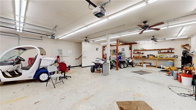 919 Venus Way, Crestline, CA 92325 - garage with ceiling fan, a workshop area, and a garage door opener