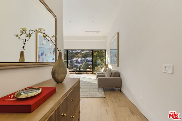 corridor with light hardwood / wood-style floors