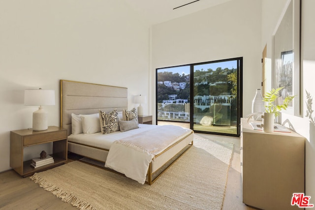 bedroom featuring hardwood / wood-style flooring and access to exterior