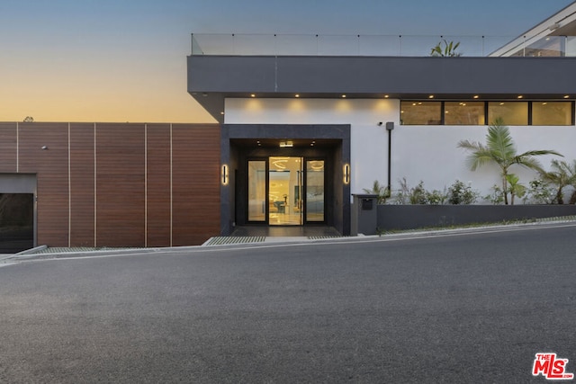 view of exterior entry at dusk