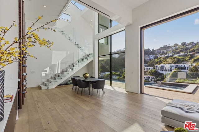 living room with hardwood / wood-style flooring and a high ceiling