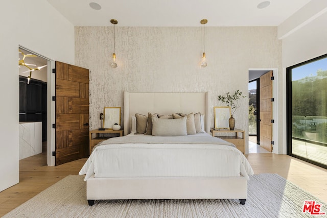 bedroom featuring light hardwood / wood-style flooring and access to outside