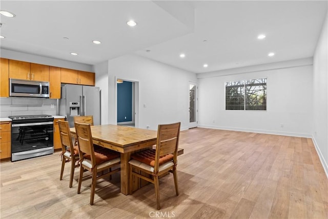 dining area with light hardwood / wood-style floors