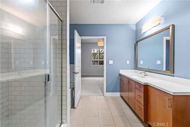 bathroom with vanity, tile patterned flooring, and walk in shower