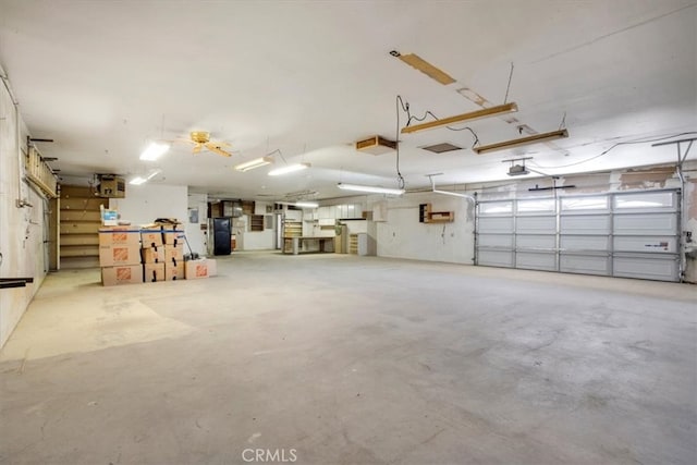 garage with a garage door opener and fridge