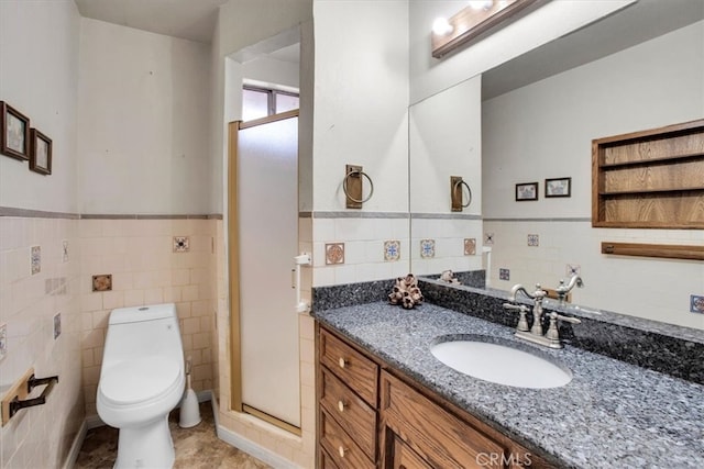 bathroom with vanity, toilet, tile patterned flooring, and tile walls