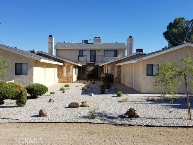 back of house featuring a balcony