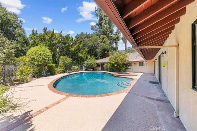 view of pool featuring a patio area and an in ground hot tub