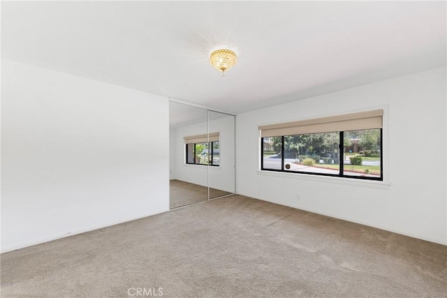 spare room featuring carpet floors and a healthy amount of sunlight