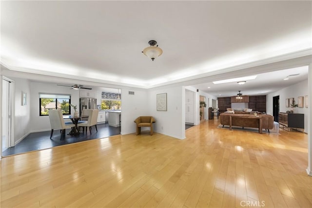 unfurnished living room featuring ceiling fan and light hardwood / wood-style floors