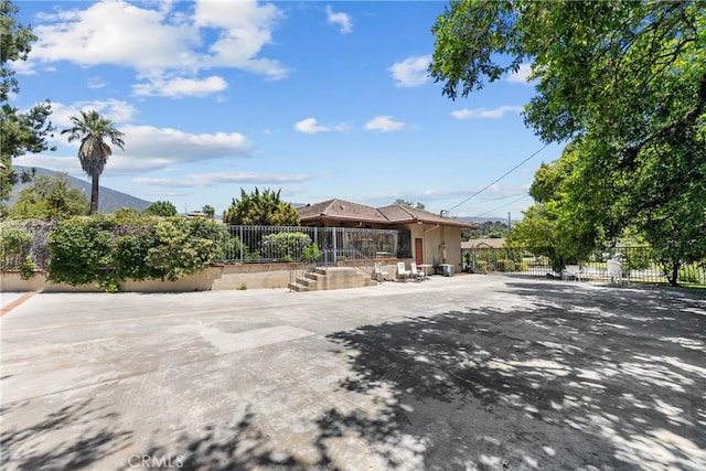 view of front of property with a mountain view and a patio