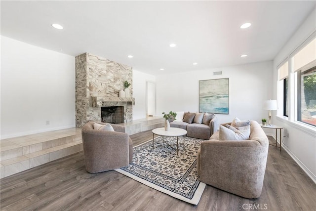 living room with hardwood / wood-style flooring and a fireplace