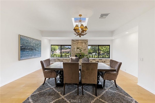 dining room featuring hardwood / wood-style floors and a chandelier