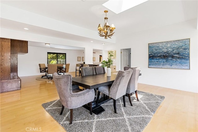 dining space featuring hardwood / wood-style flooring and a notable chandelier