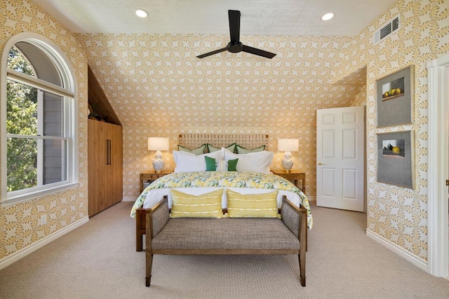 carpeted bedroom with multiple windows, lofted ceiling, and ceiling fan