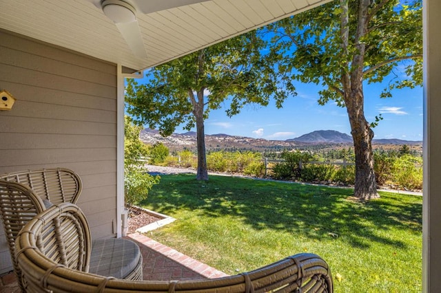 view of yard with a mountain view and ceiling fan