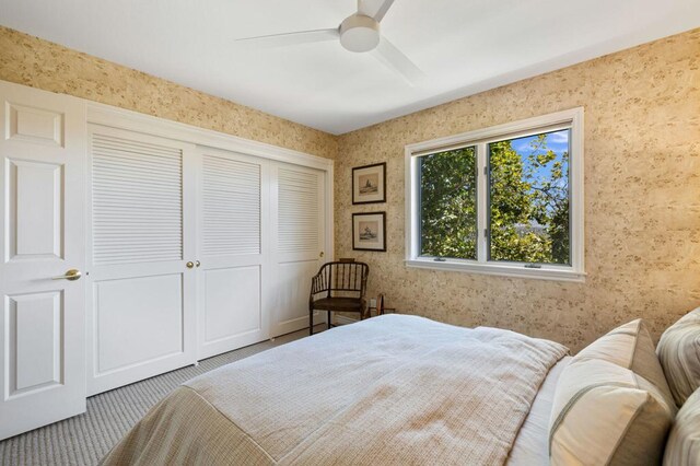 bedroom with carpet, ceiling fan, and a closet