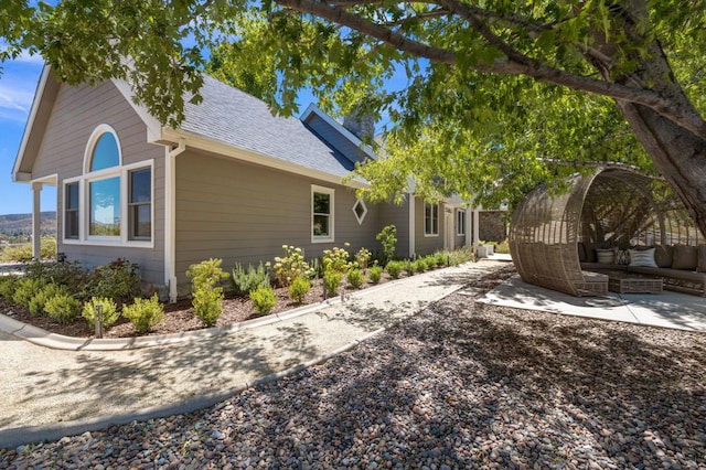 view of side of home featuring outdoor lounge area and a patio area