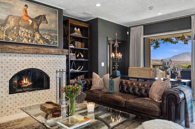 living room featuring a mountain view, a fireplace, and a chandelier