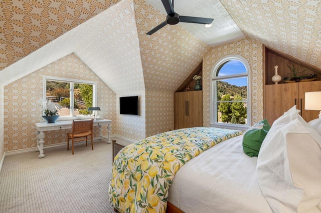 carpeted bedroom featuring vaulted ceiling, ceiling fan, and multiple windows