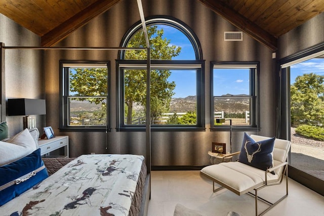 bedroom with multiple windows, wooden ceiling, and light tile patterned floors